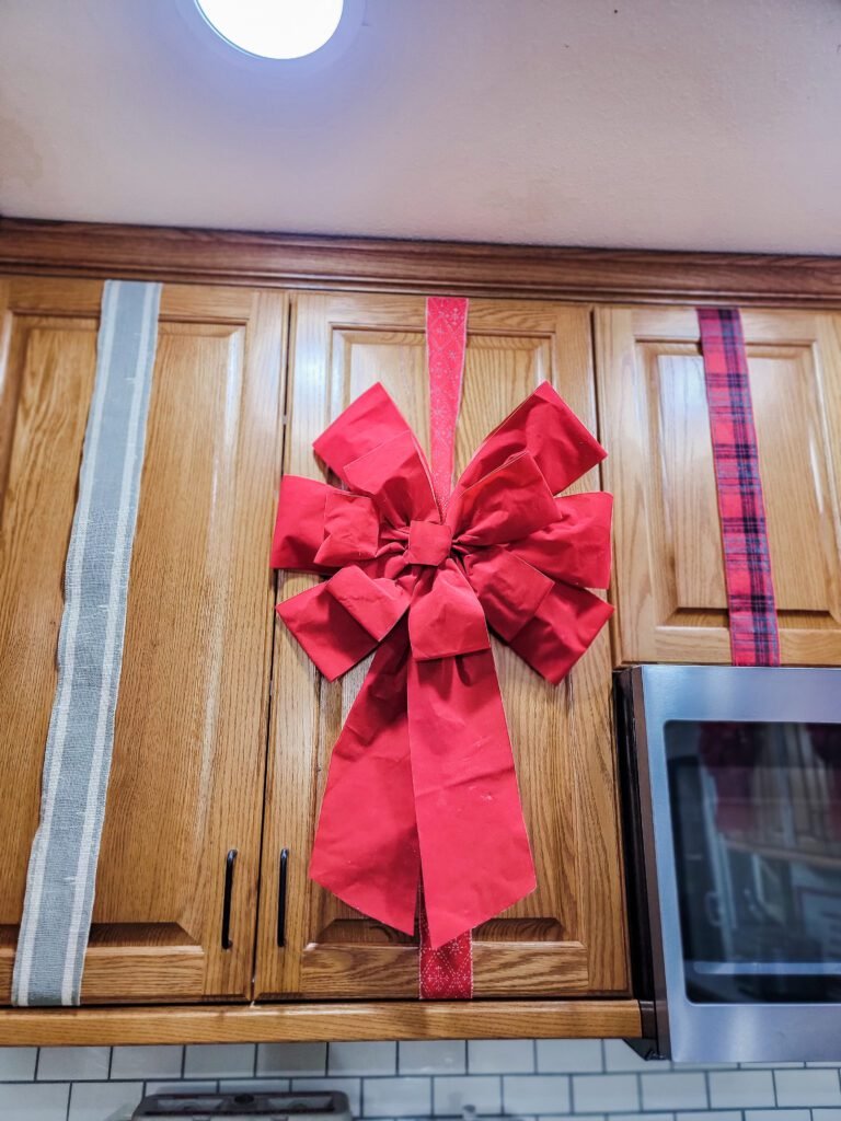 DIY cabinet bows, holiday kitchen decor, Christmas kitchen decorations, festive cabinet decoration