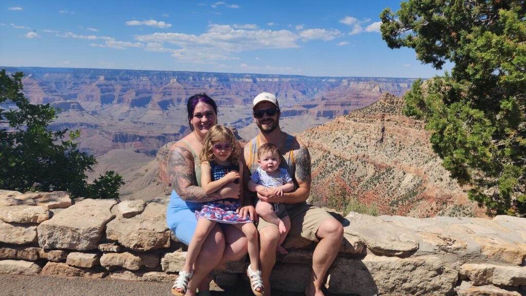 Parents and children smiling at the Grand Canyon overlook, capturing romantic travel inspiration and family connection.