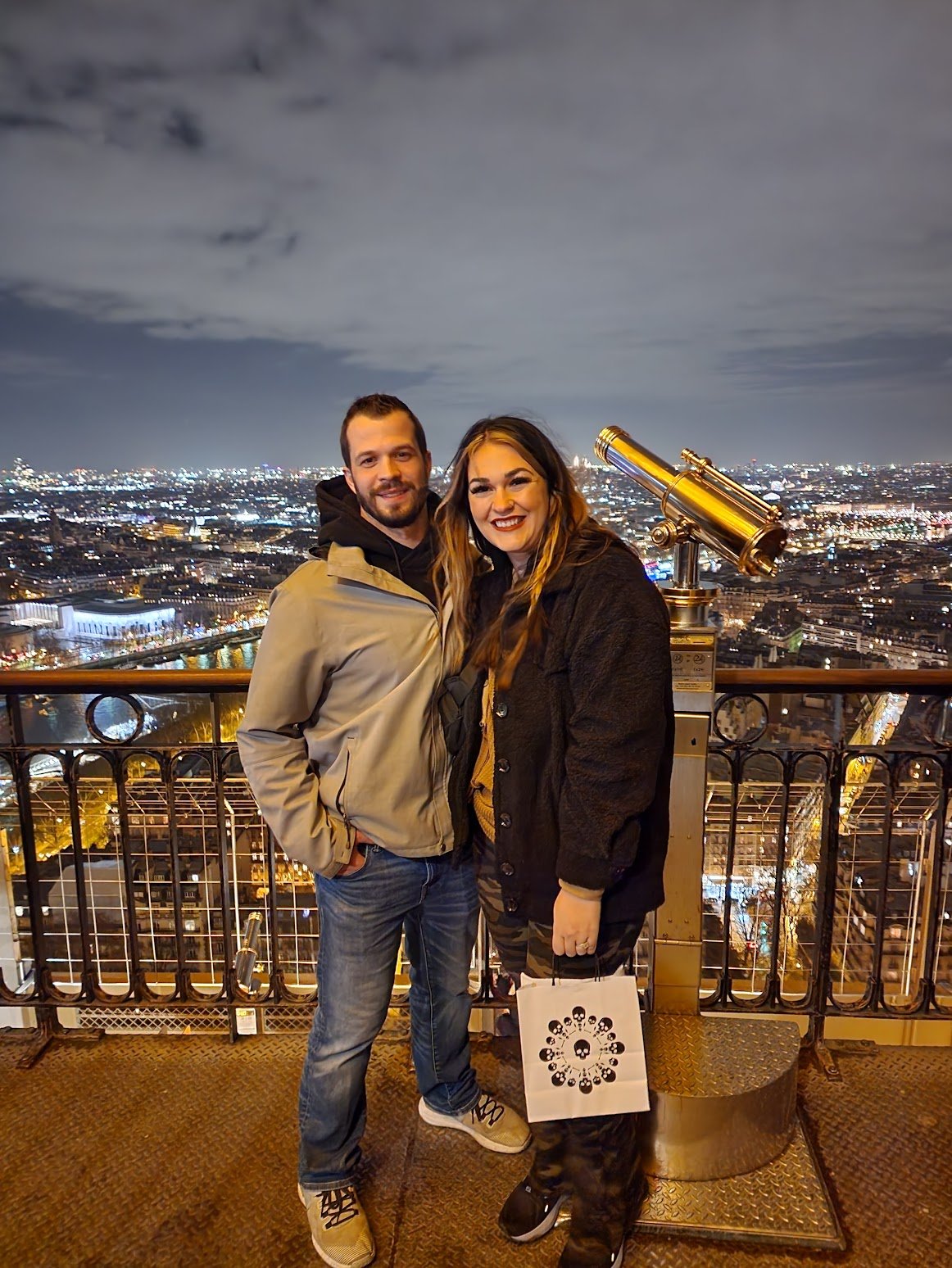 Joyful moment on the Eiffel Tower balcony, filled with romance and simple travel tips for coupl