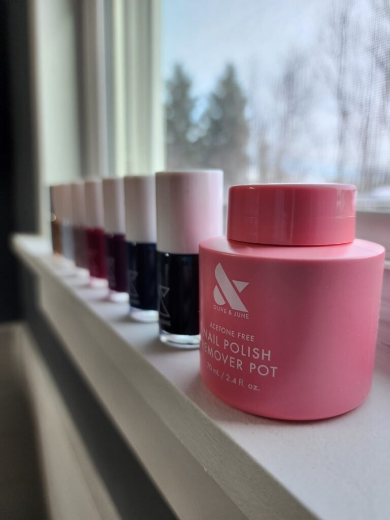 Nail polish and nail polish remover lined up aesthetically