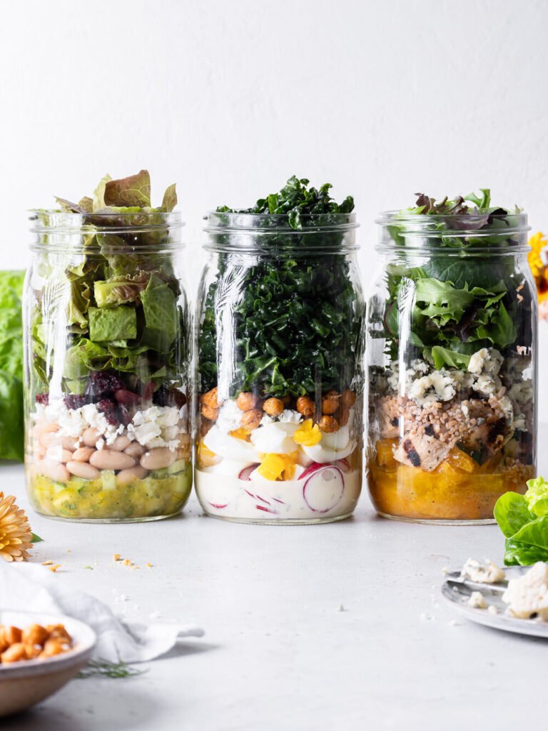 Colorful mason jar salads with fresh vegetables, a creative idea for healthy meal prep recipes and healthy recipes for New Year gatherings