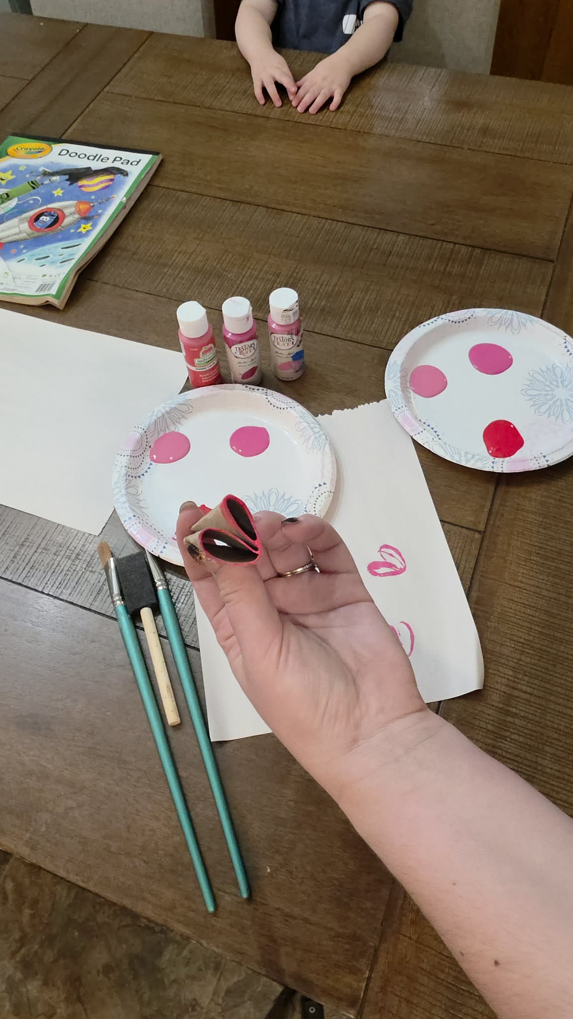 toilet paper roll folded pinched into a heart shape then pressed into the paint color kids Valentine craft ideas