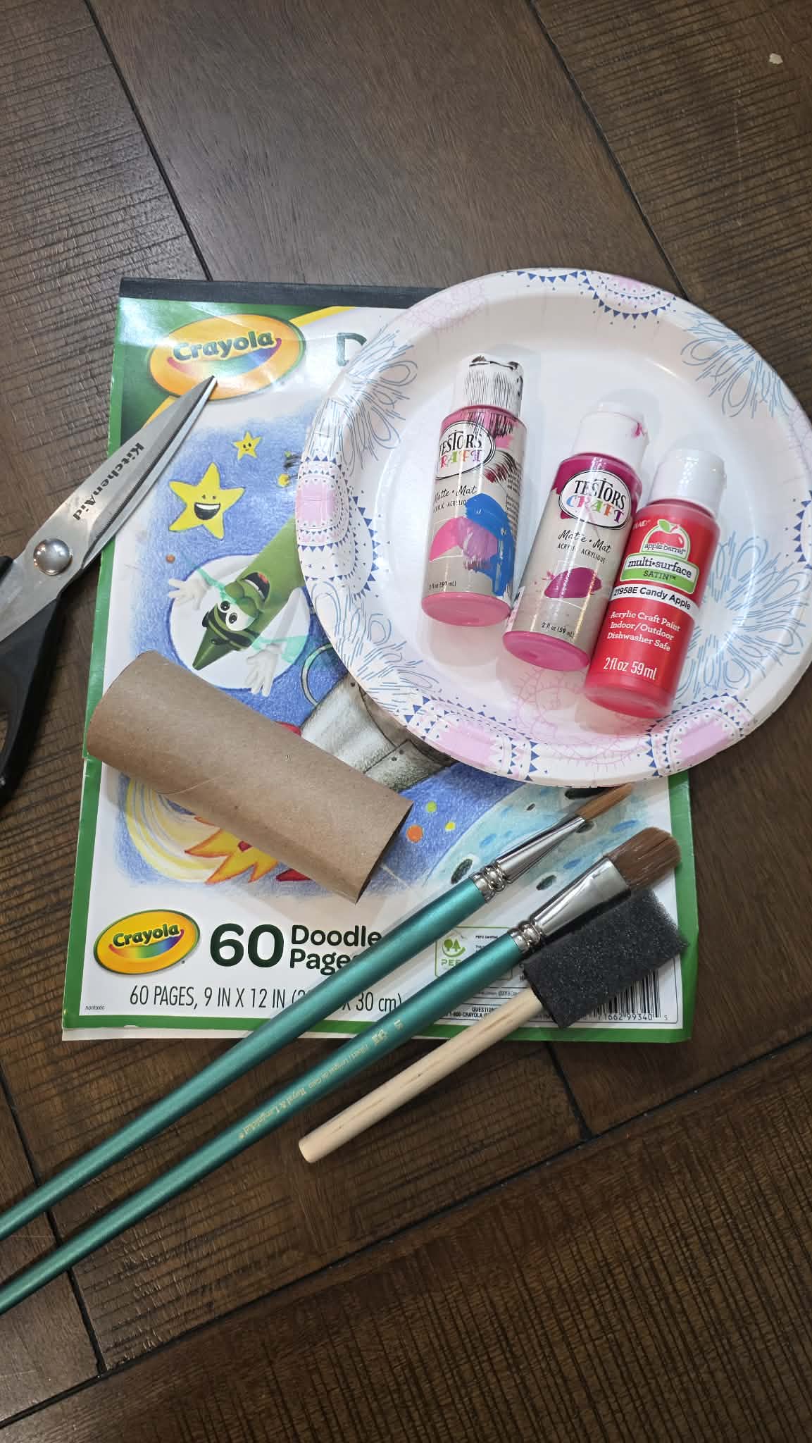 scissors, 2 colors of paint, toilet paper roll, paint brushes, paper plate, blank paper