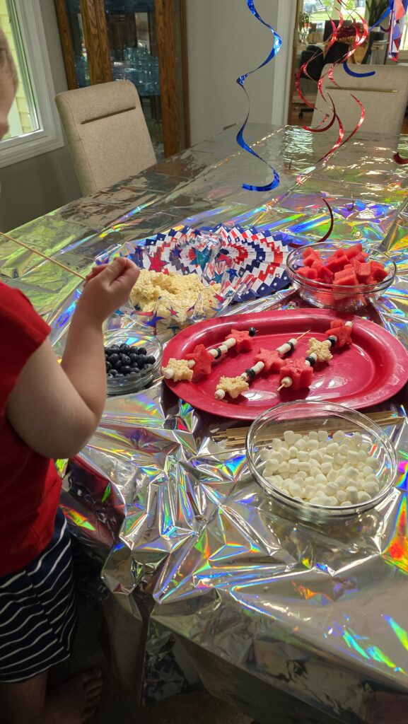 placing the fruit and marshmallows on the skewer sticks