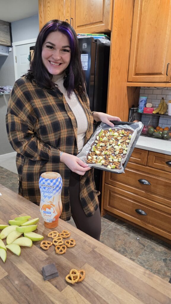 Lexie holding the finished Halloween Caramel Apple Bark