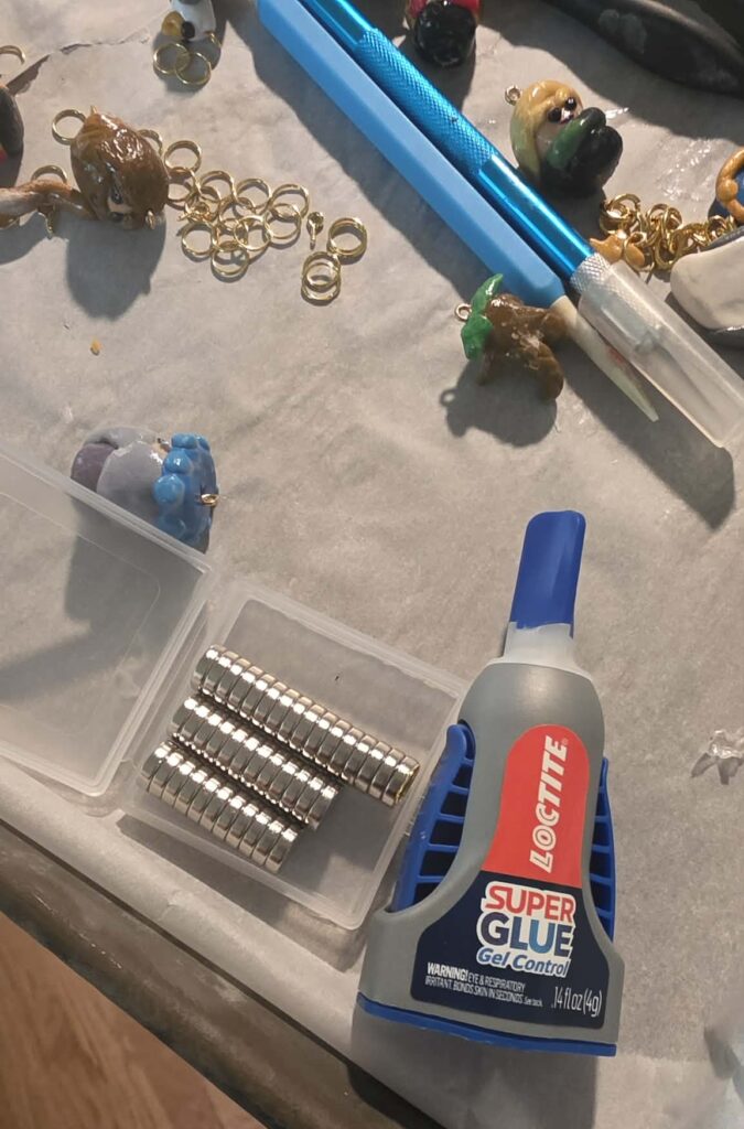 showing the magnets and super glue and charm rings used on polymer clay figures